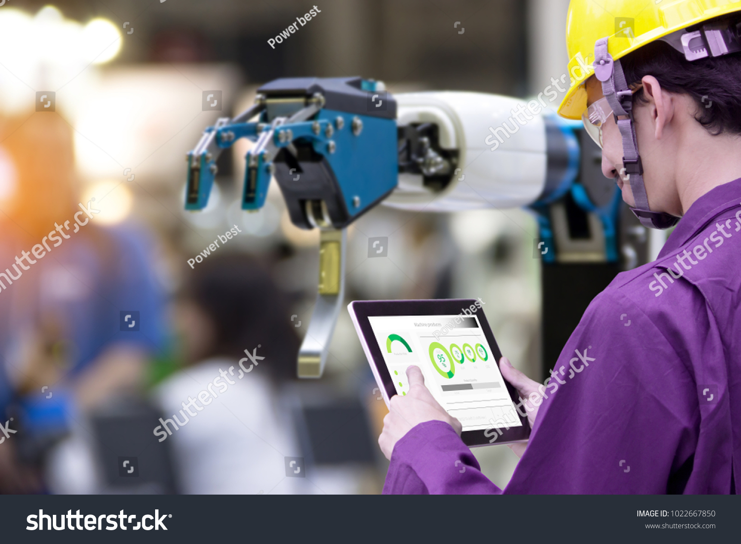 Industry 4.0 Robot concept .Engineers use laptop computers for machine maintenance automation tools robot arm at the factory.