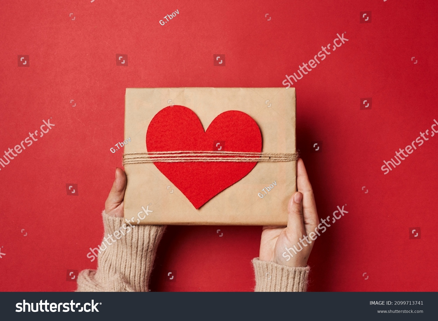 Valentines day gift on red background. Heart shape gift box with surprise. Love day concept. Anniversary mothers day womens day and birthday greeting