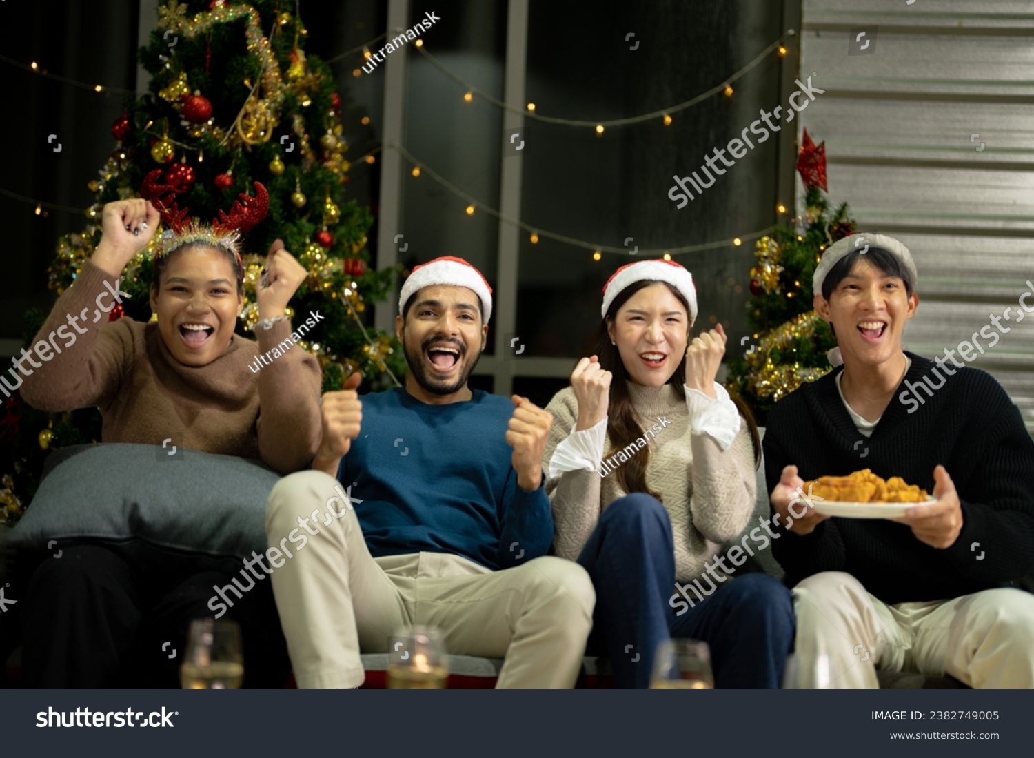 Party of beautiful asian friend female and male watching tv. people eating and having fun when watching movie. happiness friends christmas eve celebration dinner party.