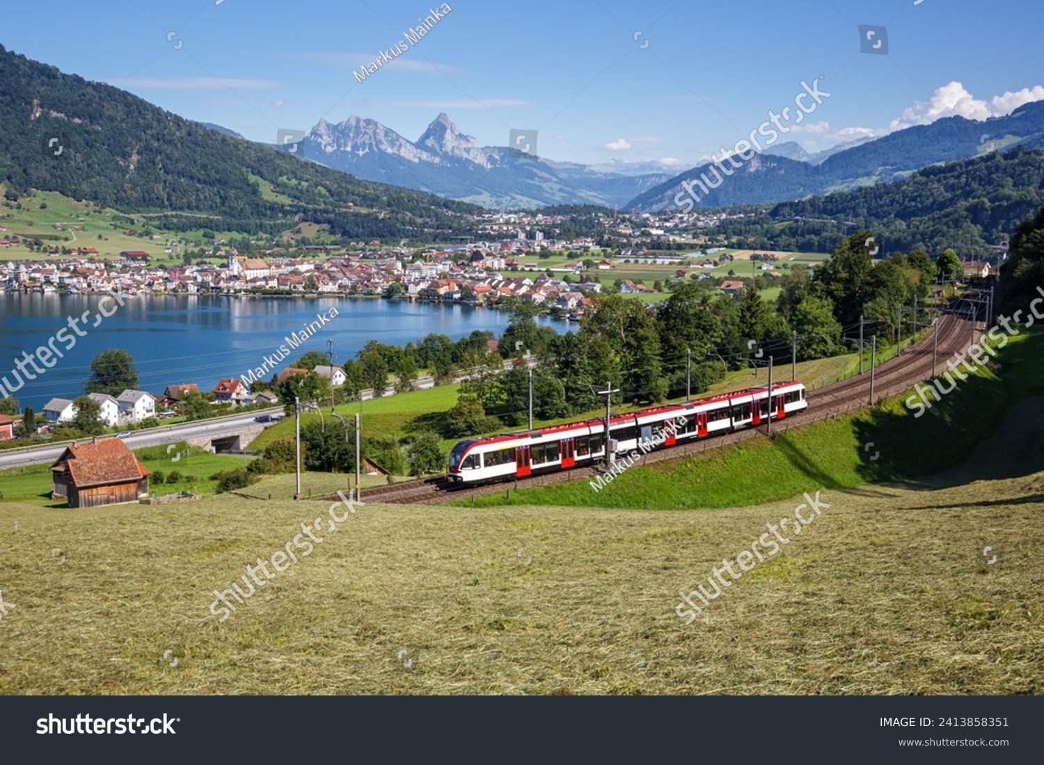 Passenger train type Stadler Flirt of Schweizerische Bundesbahnen SBB railway at Grosser Mythen mountain at Lake Zug in the Swiss Alps in Arth Switzerland
