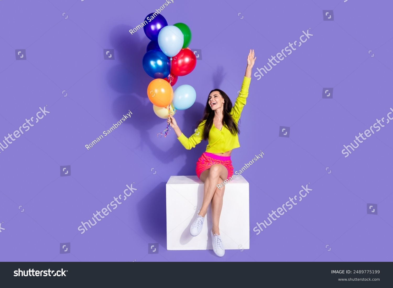 Photo of lovely cheerful girl wear trendy clothes hold helium balloon look empty space isolated on purple color background