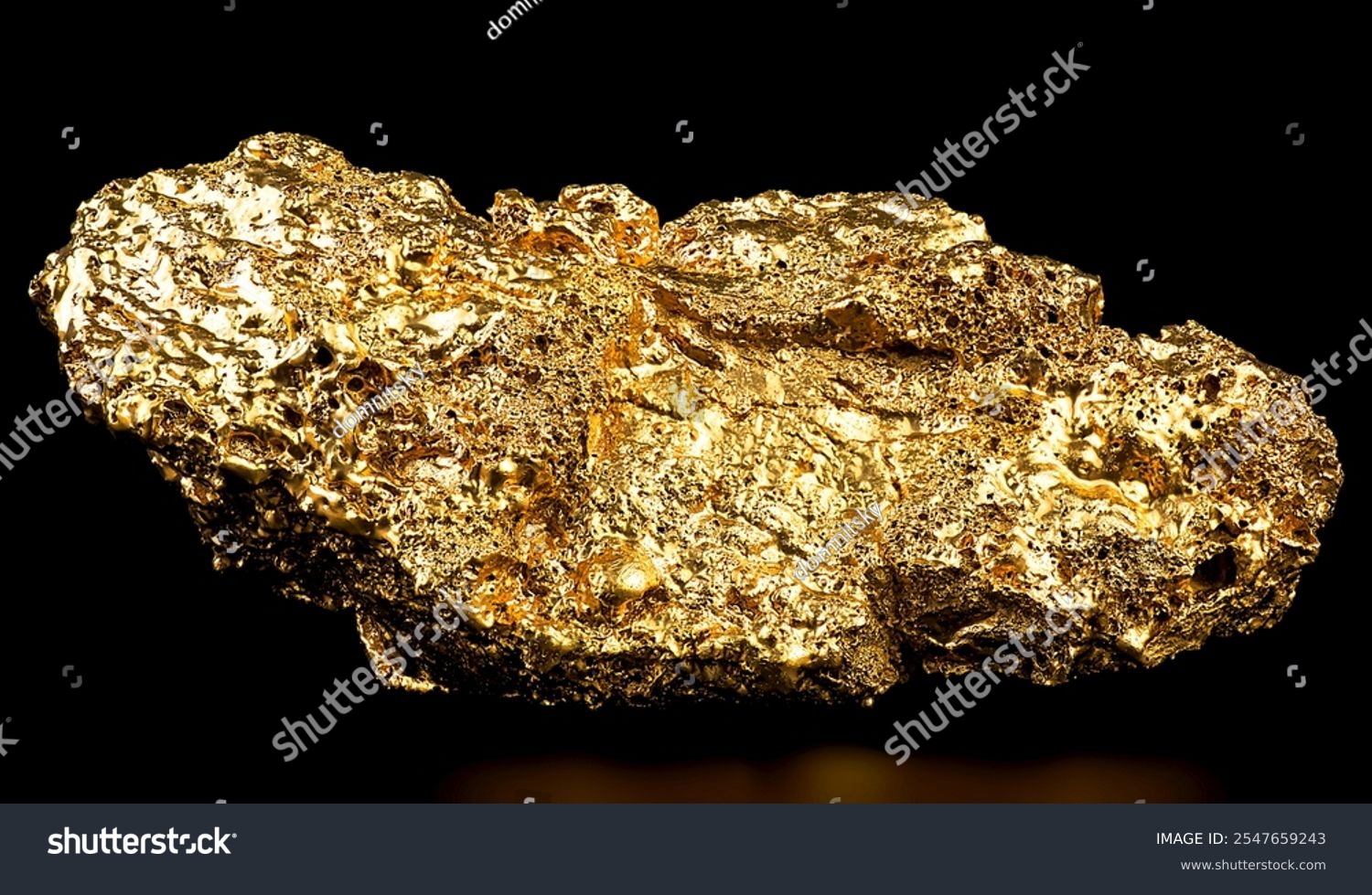 Pure gold from the mine on black background. Closeup of gold nugget. Finance and business concept.