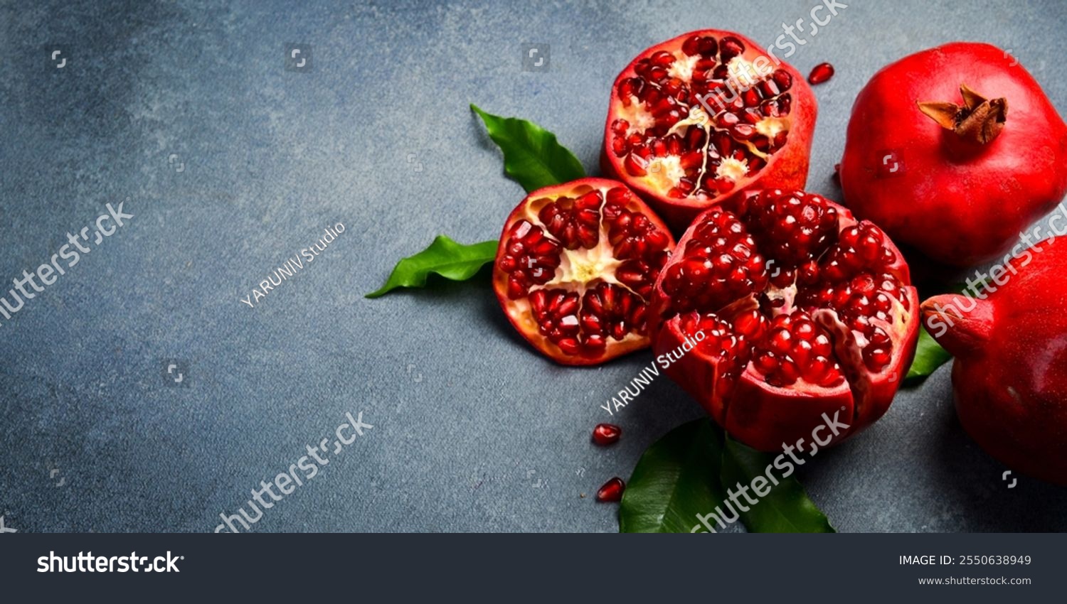 Close up. Sliced ​​ripe red pomegranate on a gray concrete background. Top view.