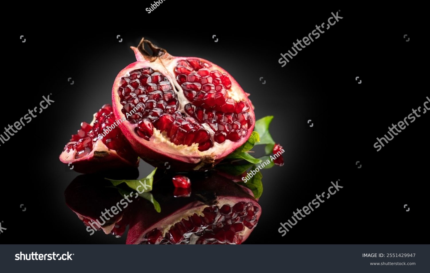 Pomegranate. Fresh juicy Pomegranates with leaves isolated on black background with reflection. Organic Bio fruits closeup. Studio shot