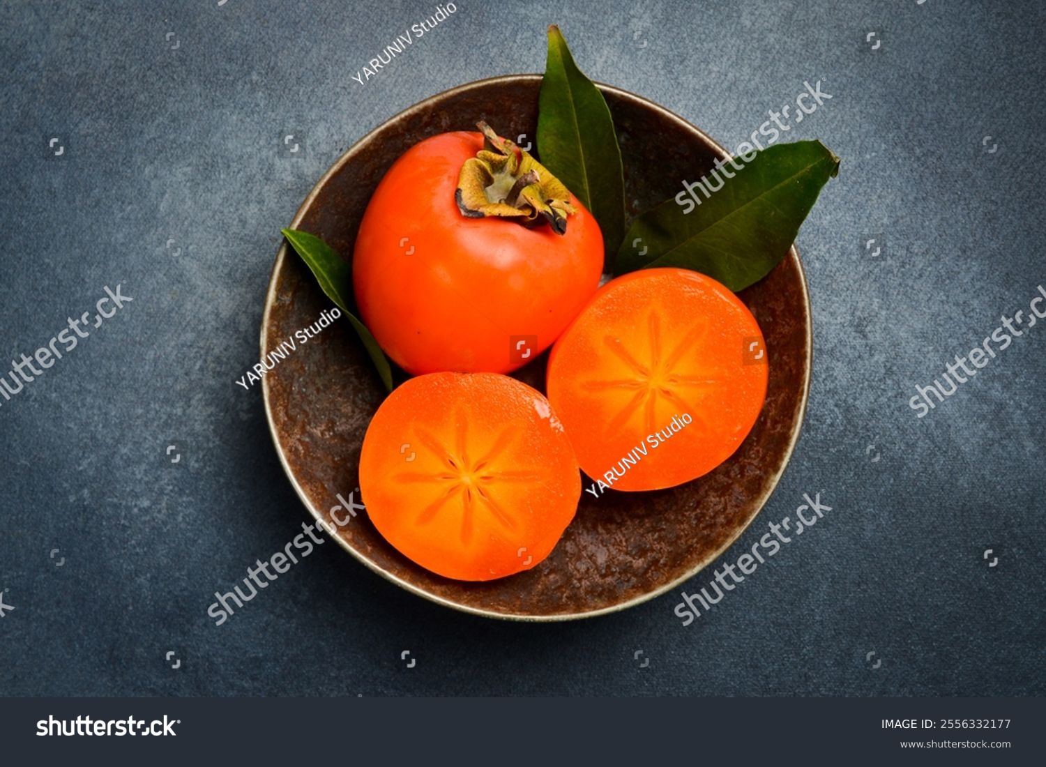 Close up  Sliced ​​persimmon fruits in a bowl. Top view.
