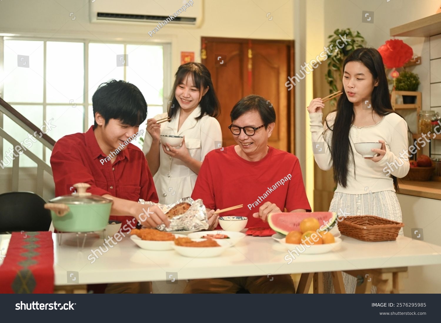 Warm asian family enjoying traditional dishes during Chinese New Year reunion dinner.