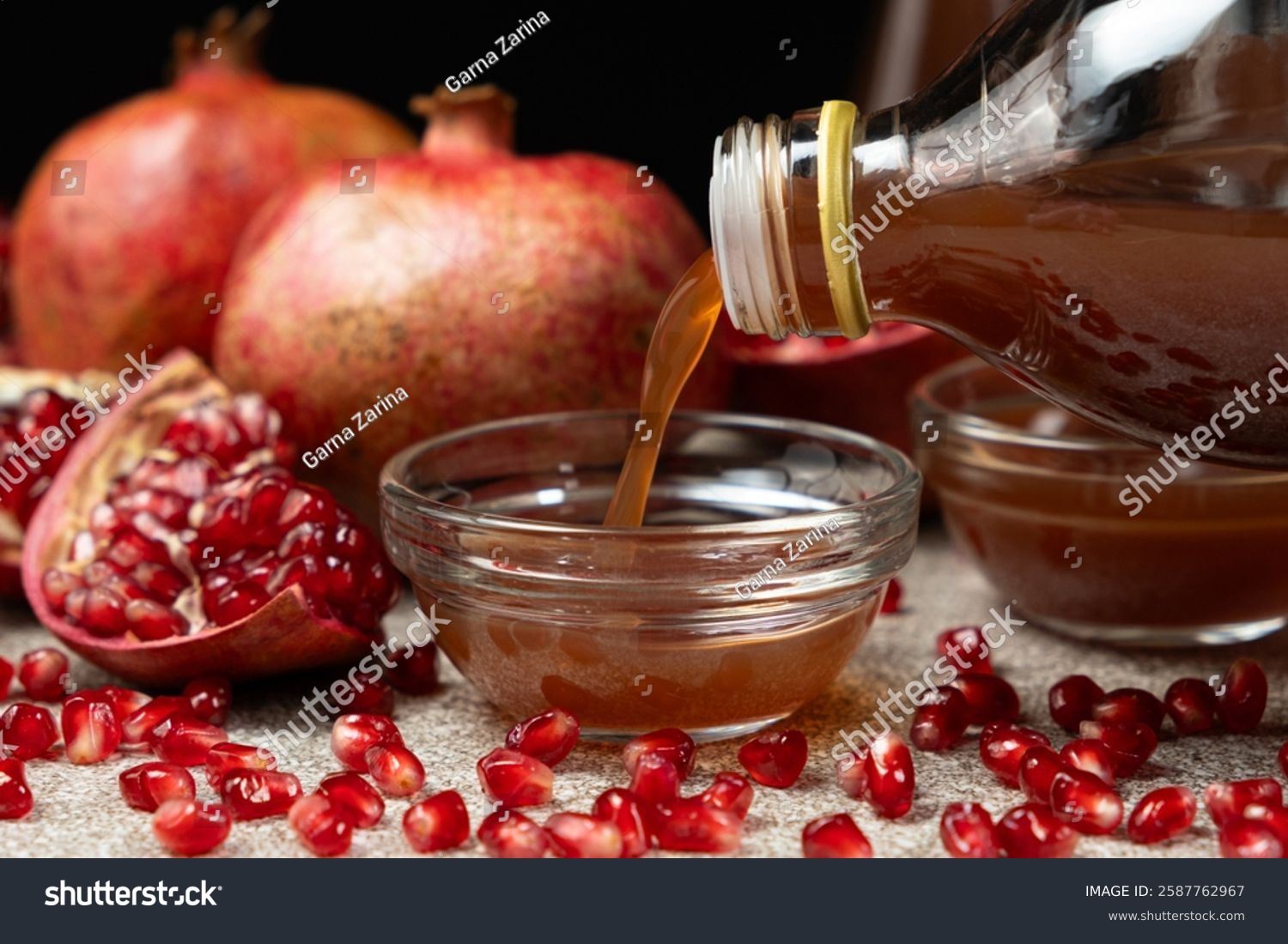 Natural Pomegranate Vinegar Pour From Bottle Into Glass Bowl.