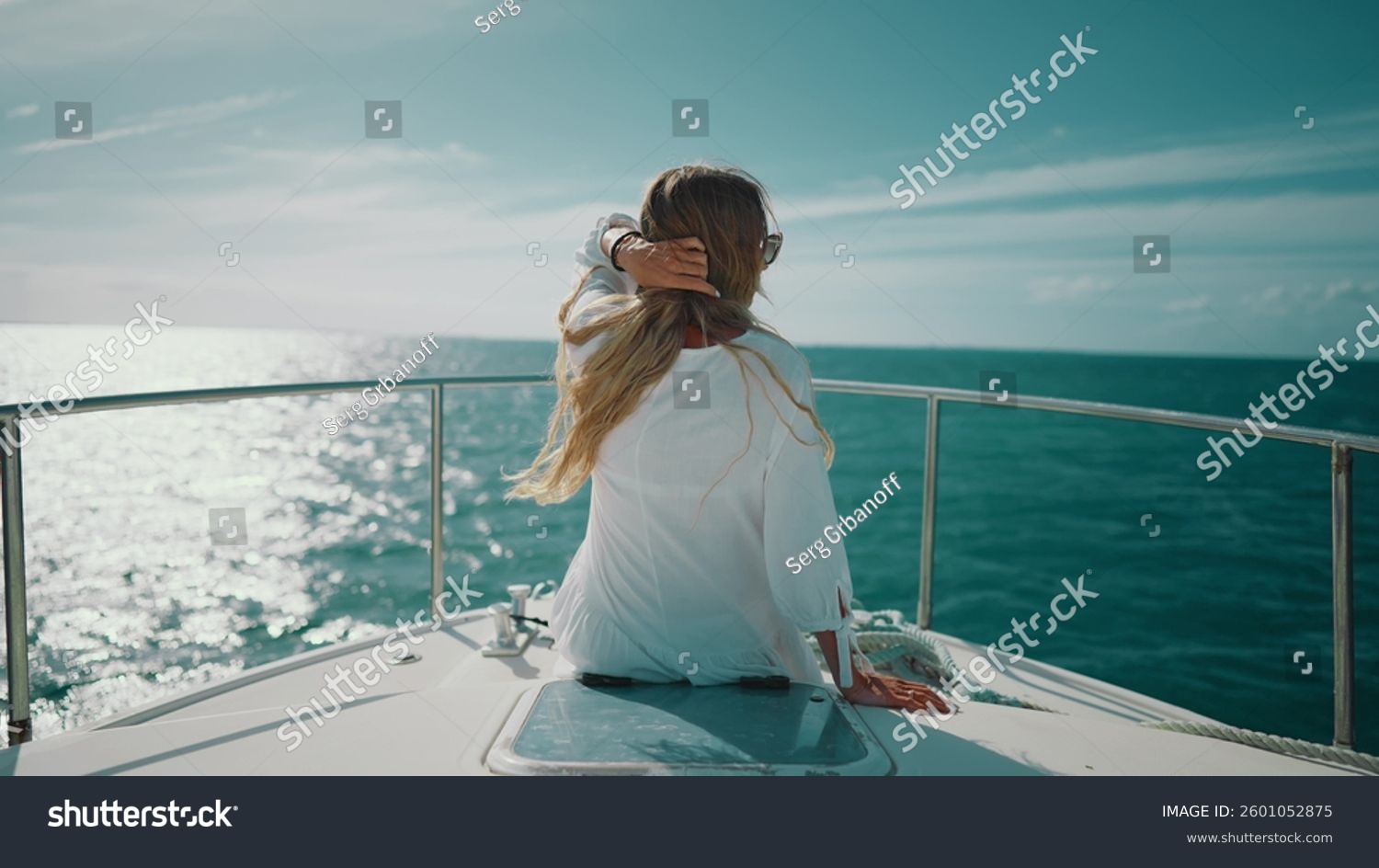 Trip to ocean by yacht back view of happy female vacationer admiring seaview. Summer vacation touristic excursion fishing in open sea woman looking to horizon rearview freedom and joy in summer