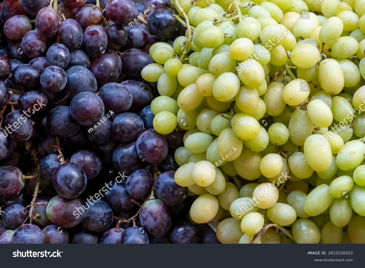 Detail of bunches of white and black grapes (Vitis vinifera) for sale at a street market