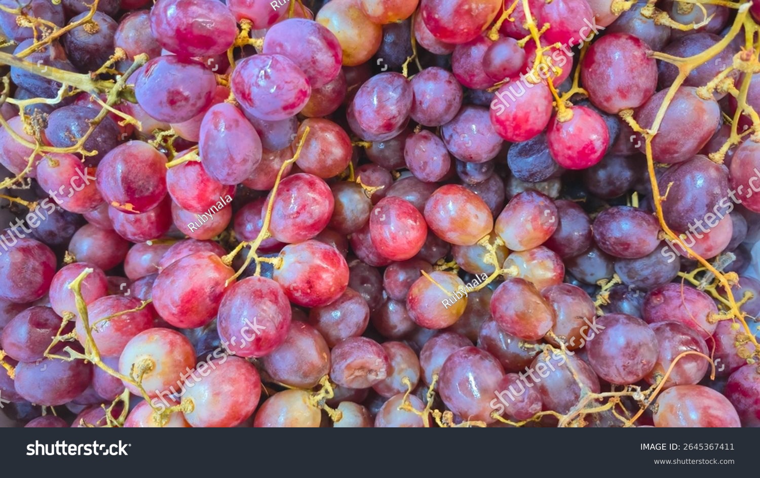Bunch of fresh red grapes ripe and sweet grapes for sale in a market. Healthy and succulent fruit.