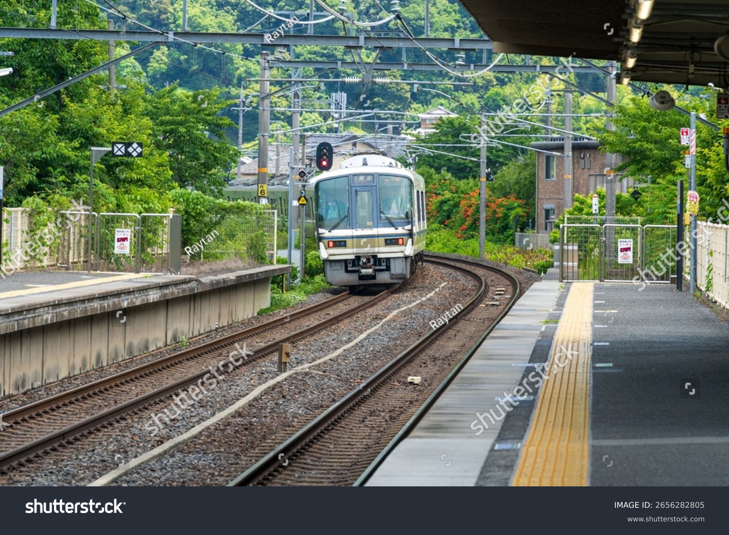 The JR West 283 series "Ocean Arrow" Kuroshio express train at a rural station platform in the Japanese countryside