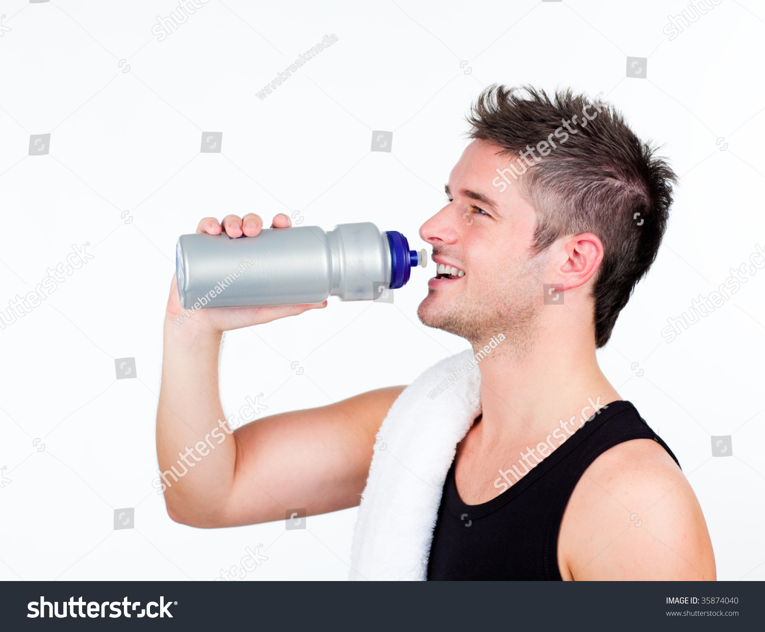 Young athletic young man holding a sports bottle
