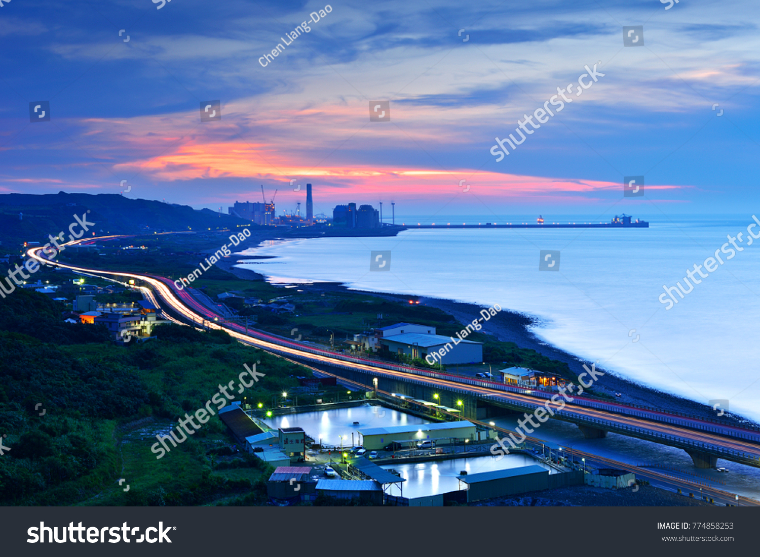 Busy harbor lights and elevated motorway light trails on the highway look very beautiful at night after sunset Taipei's new Taipei Port